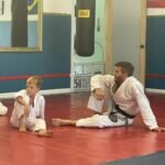 Joshua Randorf coaching a young Brazilian Jiu Jitsu student at Royce Gracie Academy Mount Pleasant SC