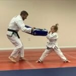 Child practicing self-defense striking drills with instructor at Royce Gracie Academy Mount Pleasant SC